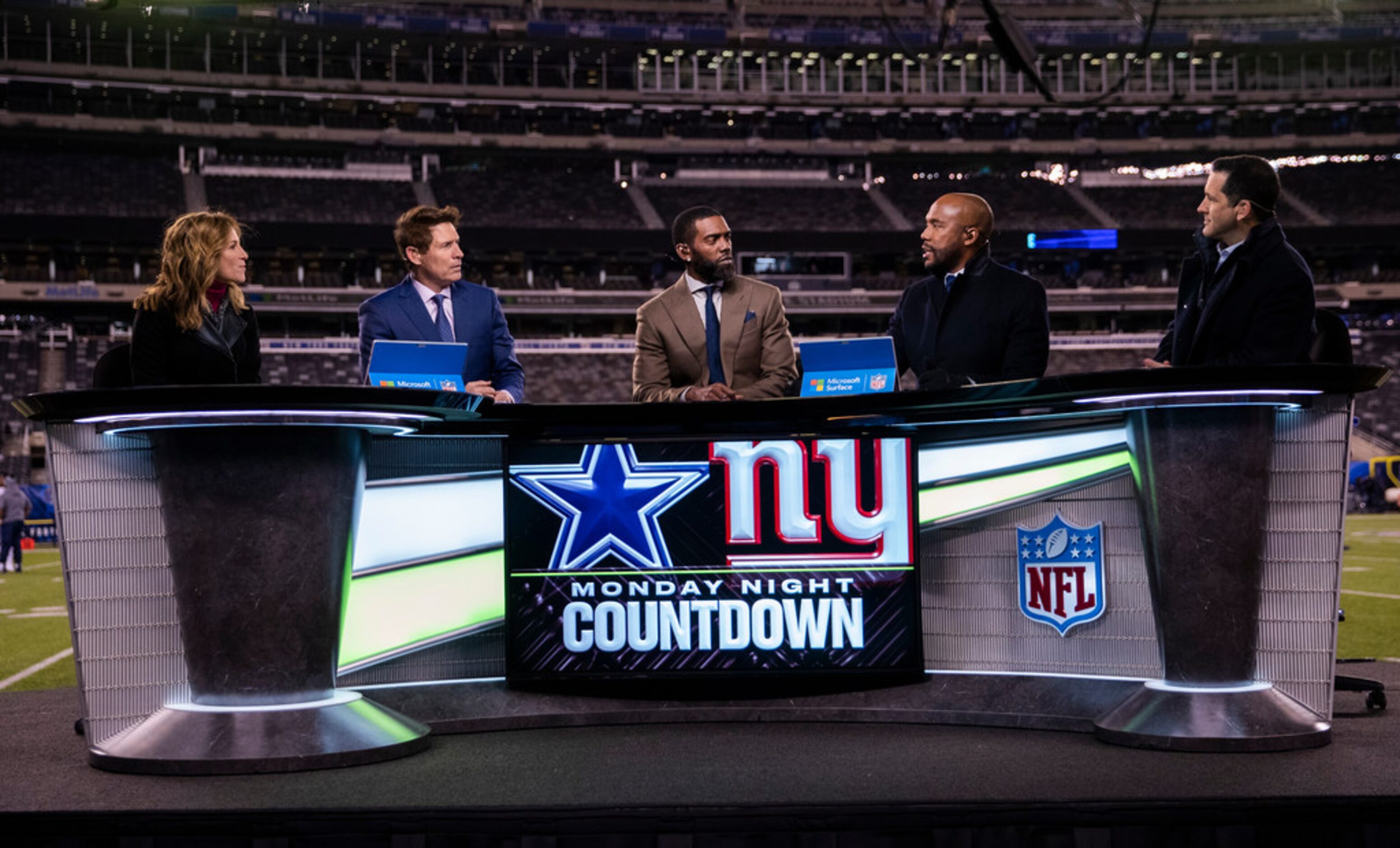 Monday Night Football announcers talk during the pregame show before an NFL game between the...