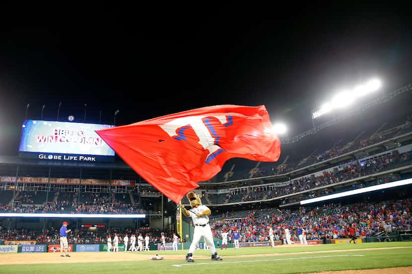 Texas Rangers mascot Captain waves a flag after a Rangers' 5-1 win over Phillies at Globe...