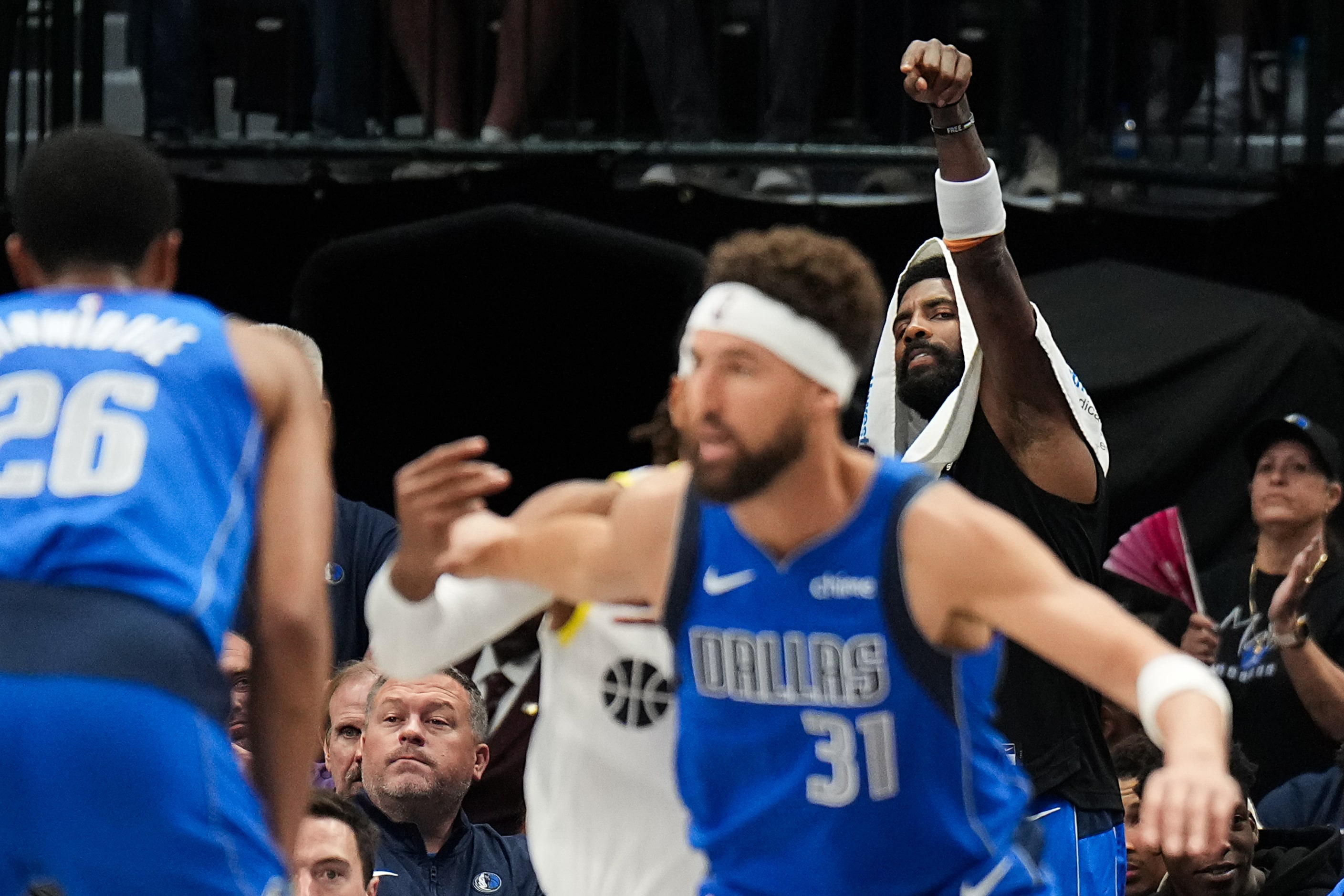 Dallas Mavericks guard Kyrie Irving points from the bench toward guard Klay Thompson (31)...