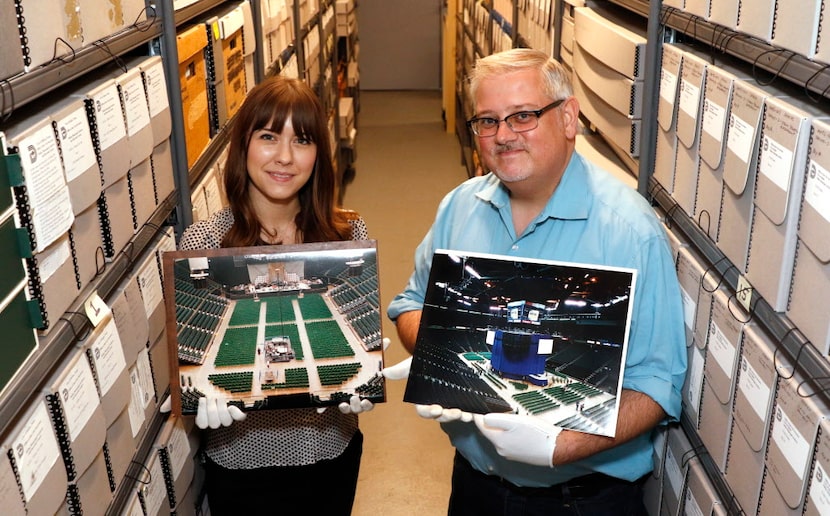 Kelley Smith, archivist volunteer, left, and John Slate, City of Dallas Archivist, hold old...