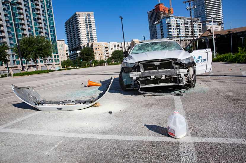 An Allied Universal Security car is left vandalized in the parking lot behind the Perot...