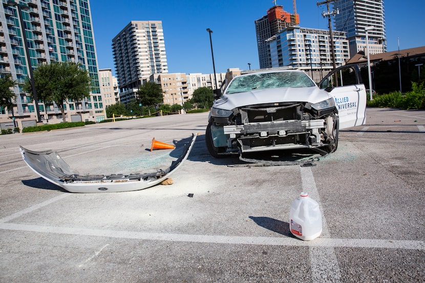 An Allied Universal Security car is left vandalized in the parking lot behind the Perot...