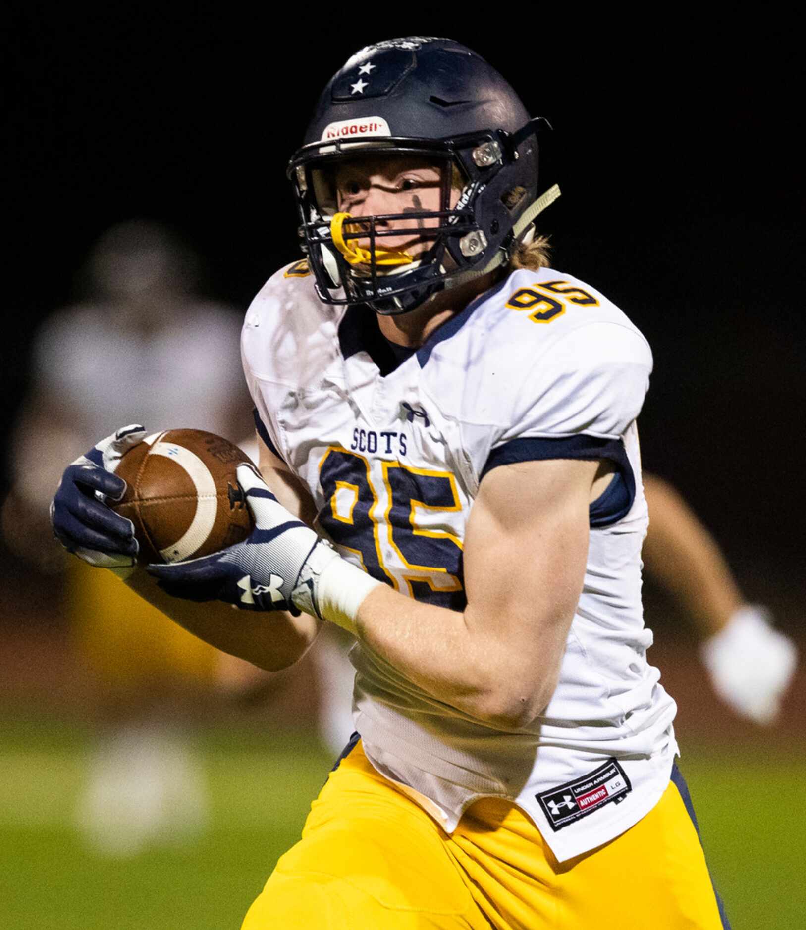 Highland Park's Jack Curtis (95) runs to the end zone for a touchdown during the first...