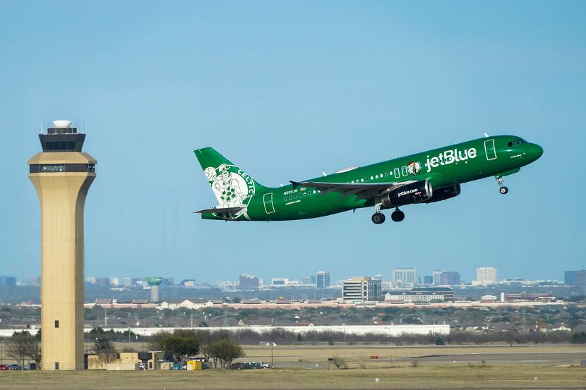 A JetBlue A320 named "Lucky Blue" and painted in the livery of the Boston Celtics takes off...