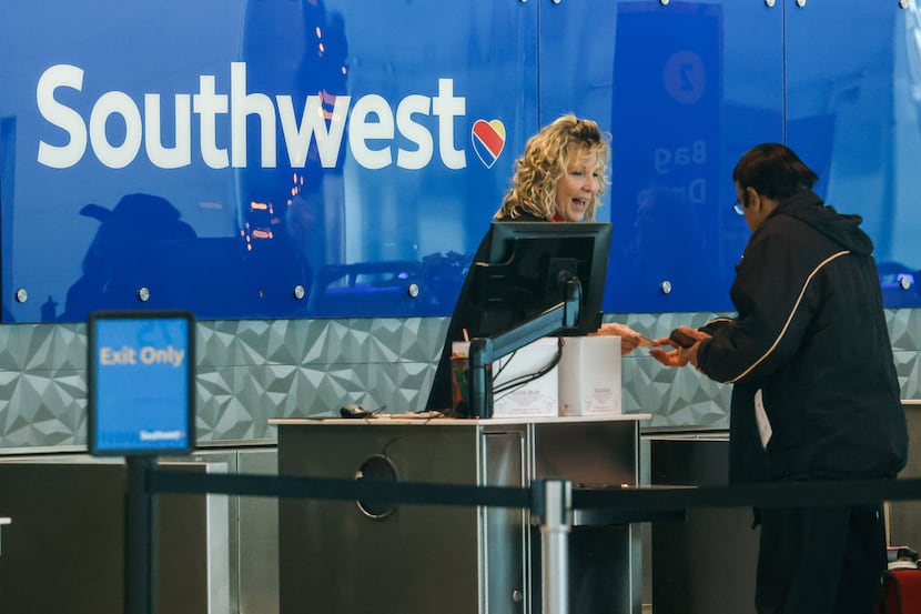 Southwest Airlines worker assists customers at Dallas Love Field airport in Dallas on...