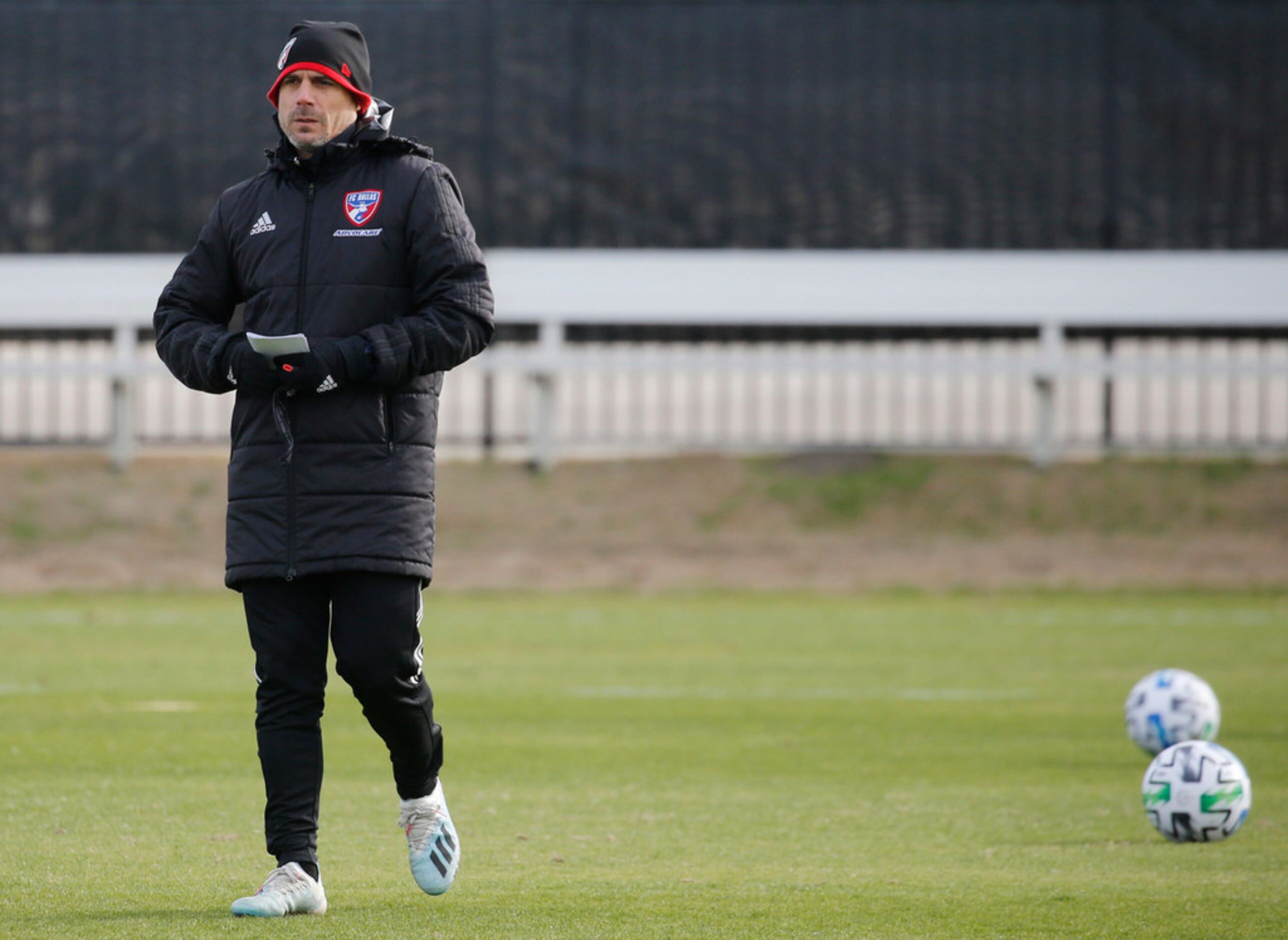 FC Dallas head coach Luchi Gonzalez watches players during the first practice of preseason...