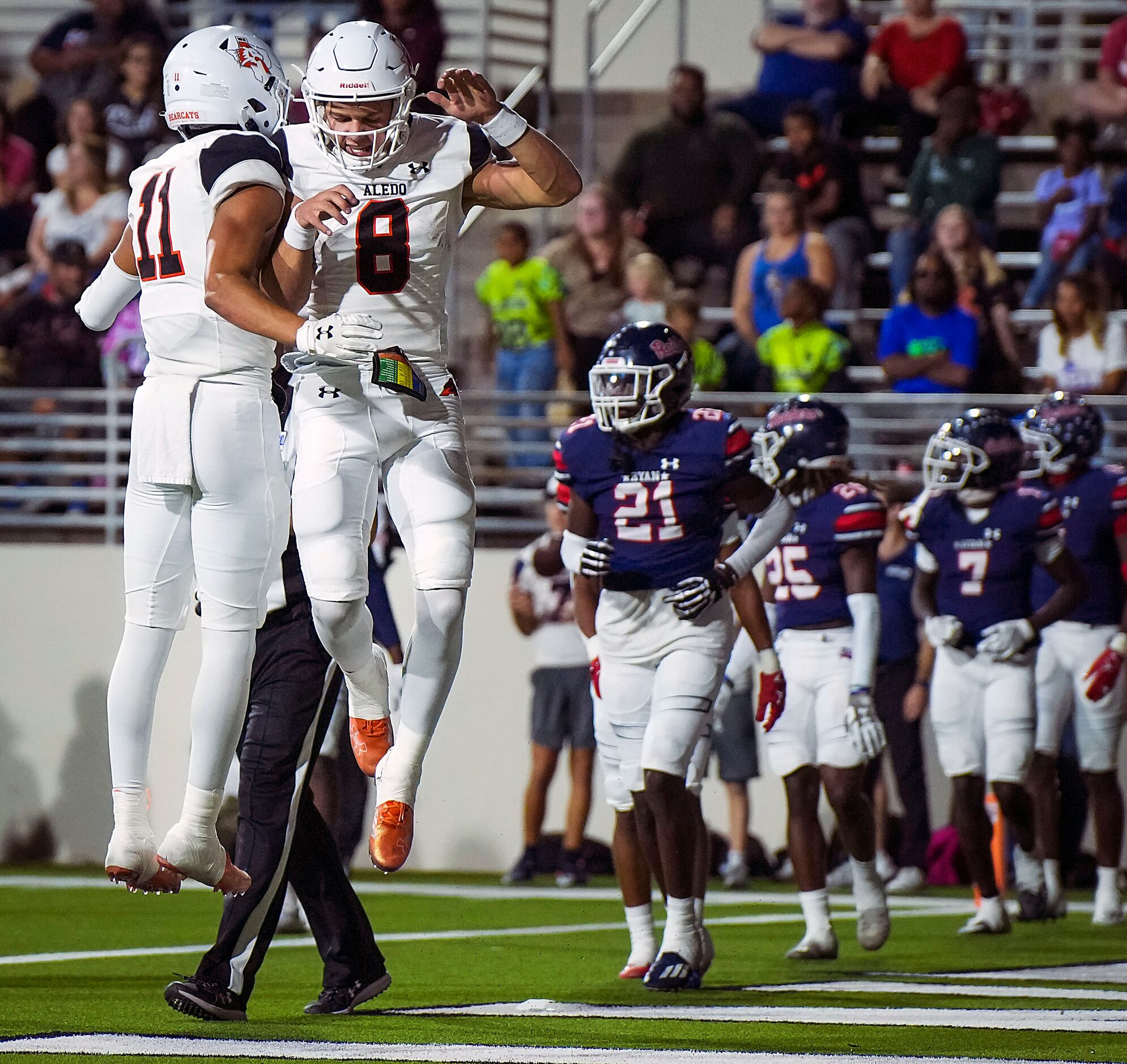 Aledo quarterback Hauss Hejny (8) cele brates with wide receiver Jalen Pope (11) after...