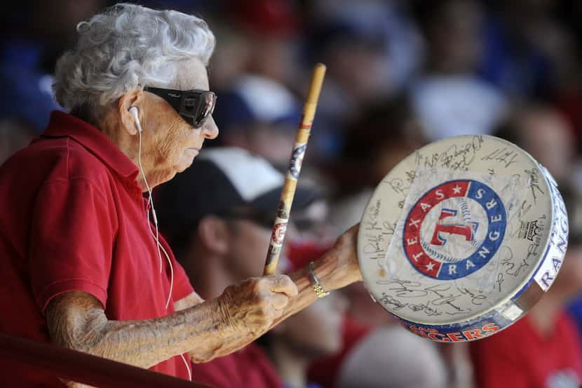 Sister Frances Evans, 84 of Fort Worth, tries to pump up the surrounding fans with her drum...