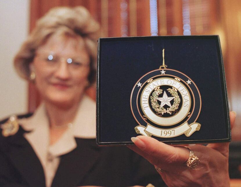 ORG XMIT: AT101 Nelda Laney displays the 1997 Texas Capitol ornament going on sale during an...