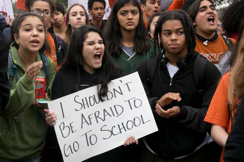 Maya Morales, 15, holds a sign during a walkout and demonstration for gun control at...