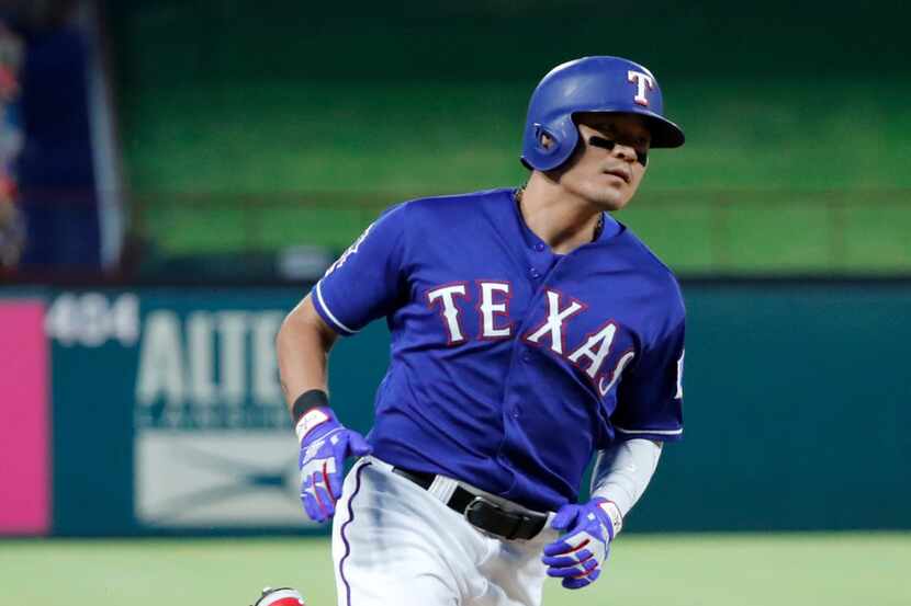 Texas Rangers' Shin-Soo Choo sprints home to score during a baseball game against the...