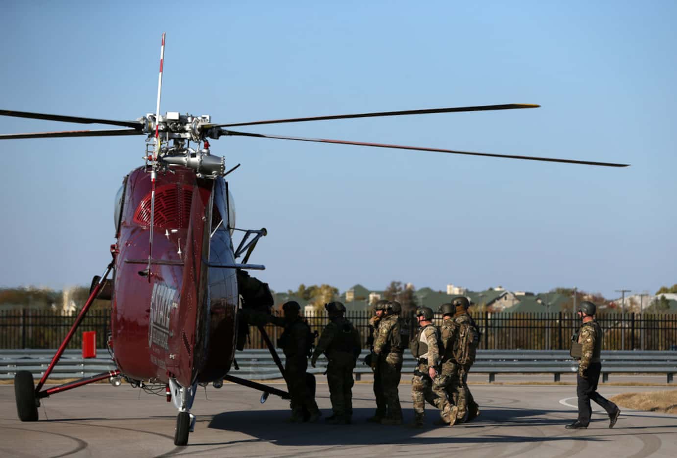Plano SWAT officers board a helicopter after a fast-rope exercise onto a staging building at...