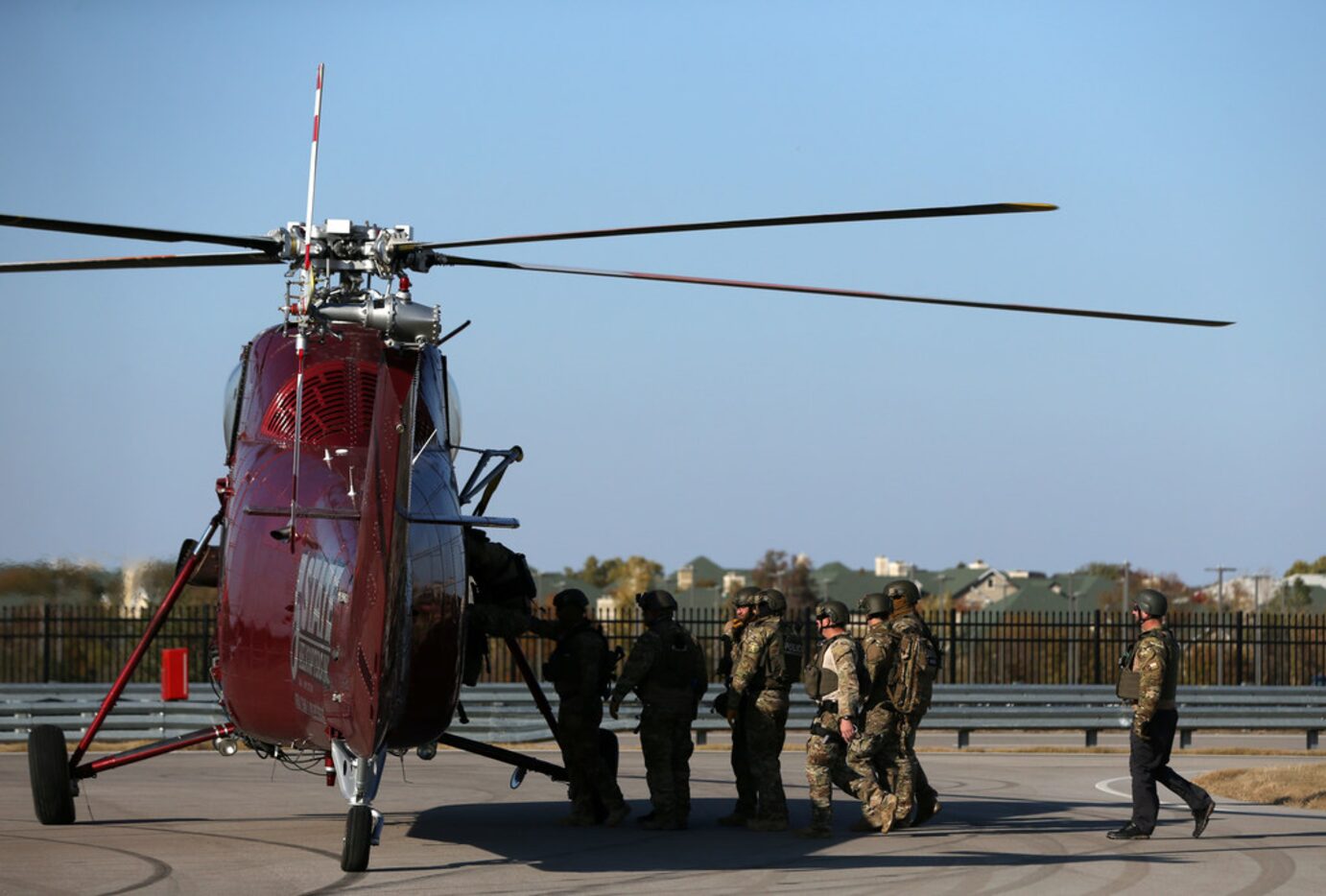 Plano SWAT officers board a helicopter after a fast-rope exercise onto a staging building at...