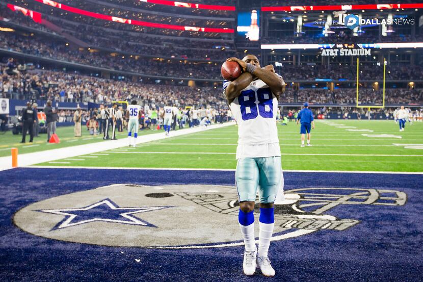 Dallas Cowboys wide receiver Dez Bryant throws the "X" to the crowd before an NFL football...
