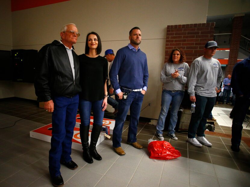 GA Moore (from left) Valerie Moore, Gary Don Moore wait to be presented at an auction for...