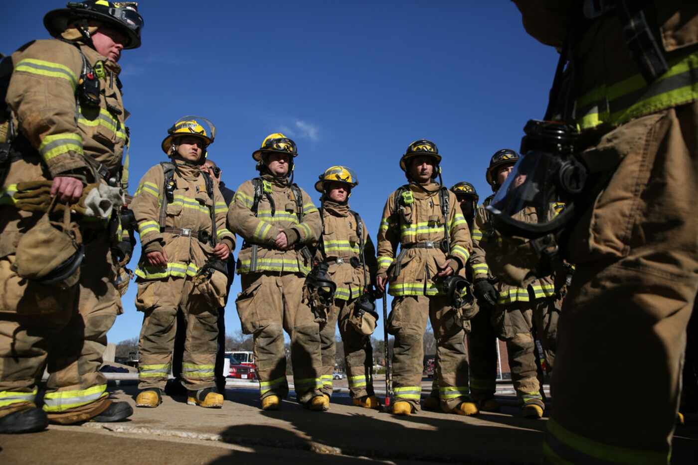 Dallas Fire-Rescue recruits gather to debrief after fire scenario training at the Dallas...