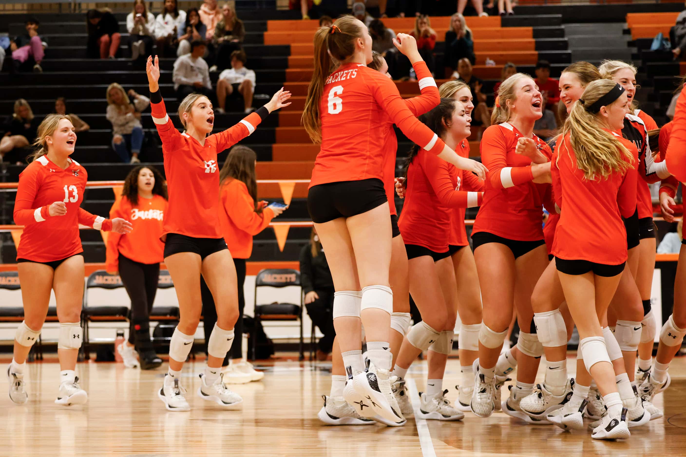 Rockwall high players celebrate after winning against Rockwell Heath during a volleyball...