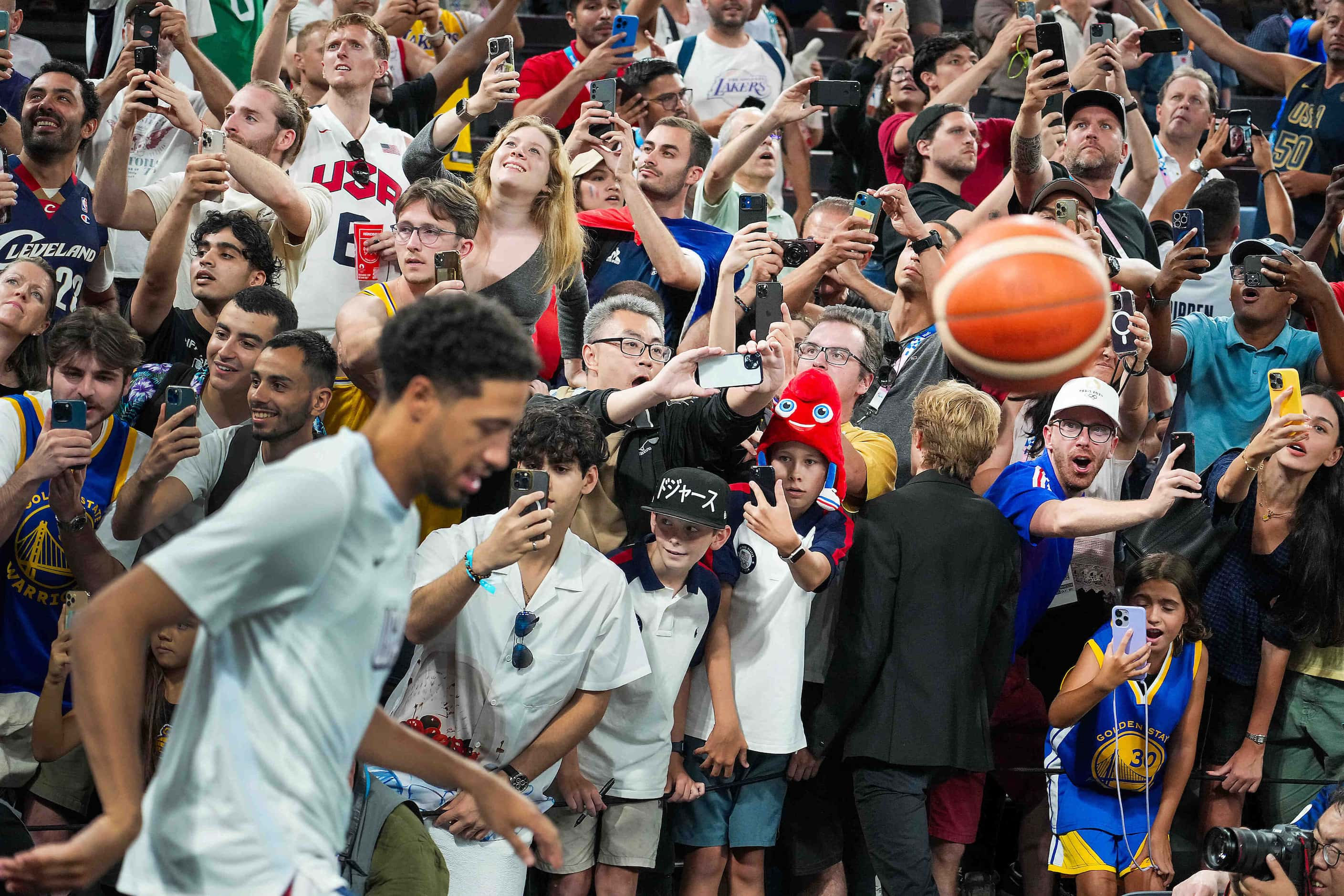 Tyrese Haliburton of the United States takes the court past fans cheering and clamor for...