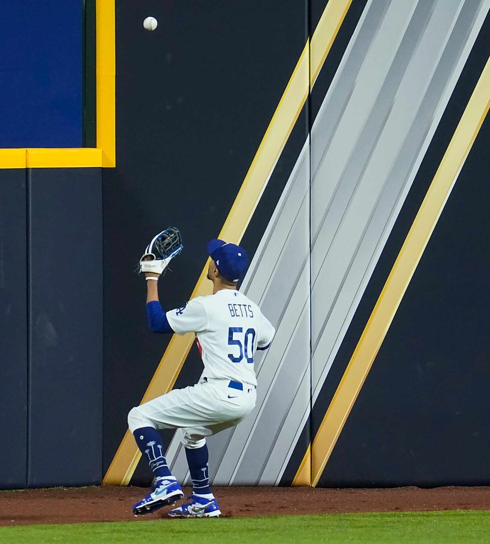 Los Angeles Dodgers right fielder Mookie Betts chases down a double off the bat of Tampa Bay...