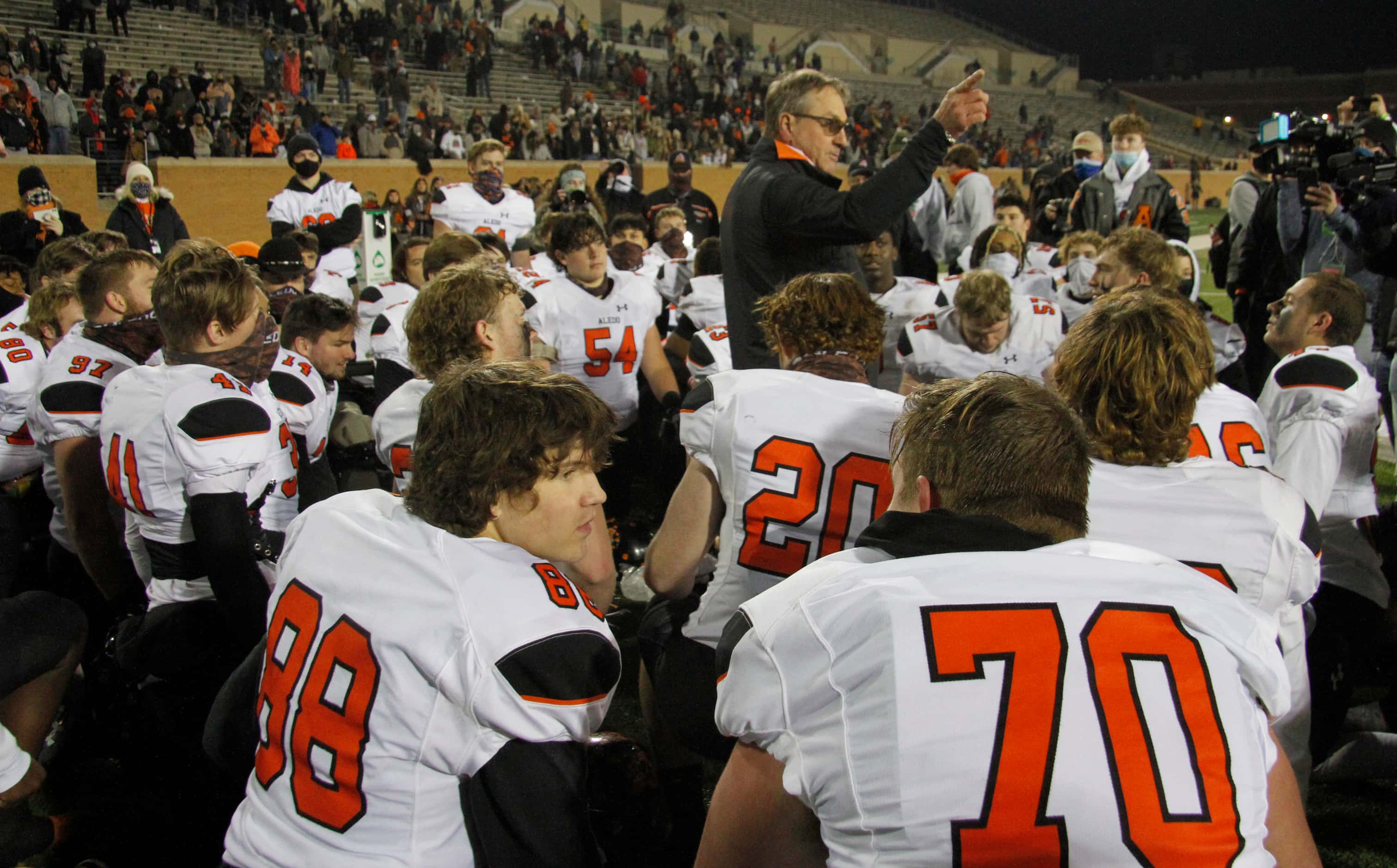 Aledo head coach Tim Buchanan makes a point as he shares a message with his players...