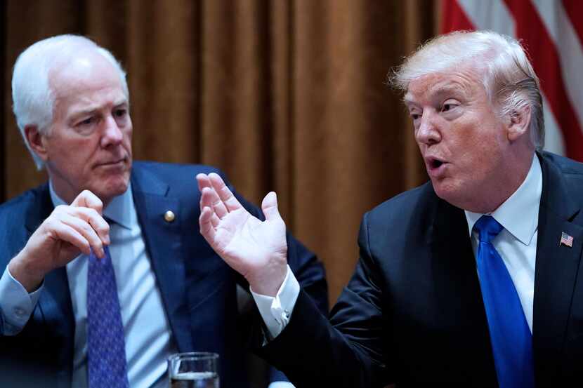 Sen. John Cornyn listens to President Donald Trump during a White House meeting with...