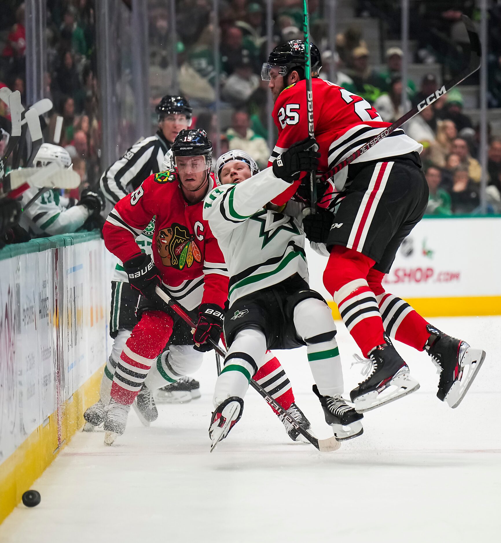 Dallas Stars center Ty Dellandrea (10) is knocked to the ice by Chicago Blackhawks...