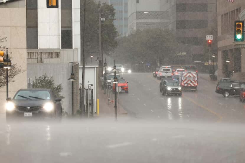 Rain is expected to fall off and on Saturday. Pictured, a thunderstorm hits downtown Dallas...