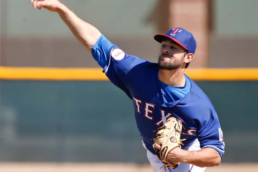 Texas Rangers starting pitcher Nick Martinez works in an intrasquad game prior to a spring...