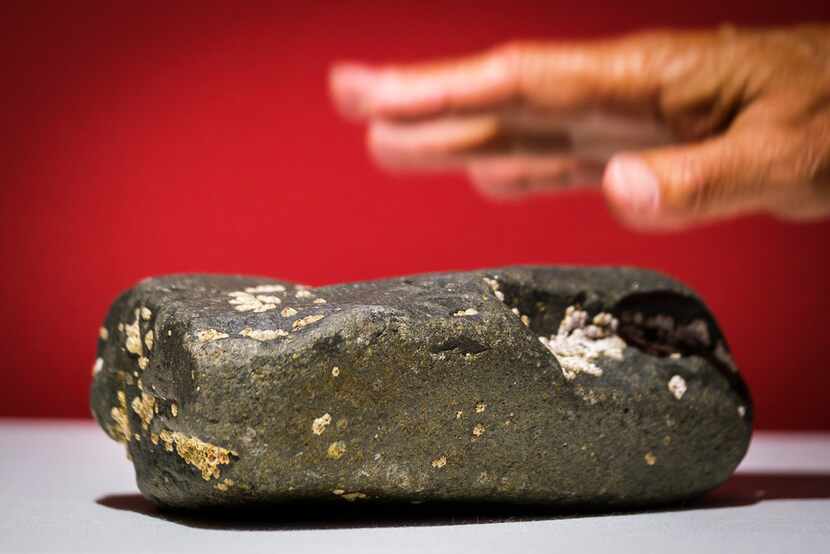 Bernard Kinsey points out a Goree Island Rock from Senegal during the installation of the...