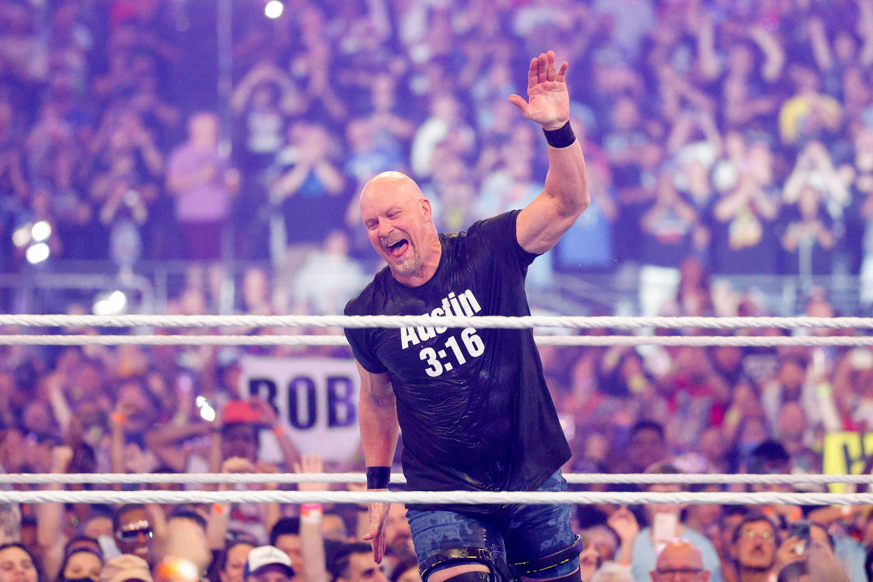 “Stone Cold” Steve Austin runs around the ring after a match against Vince McMahon at...
