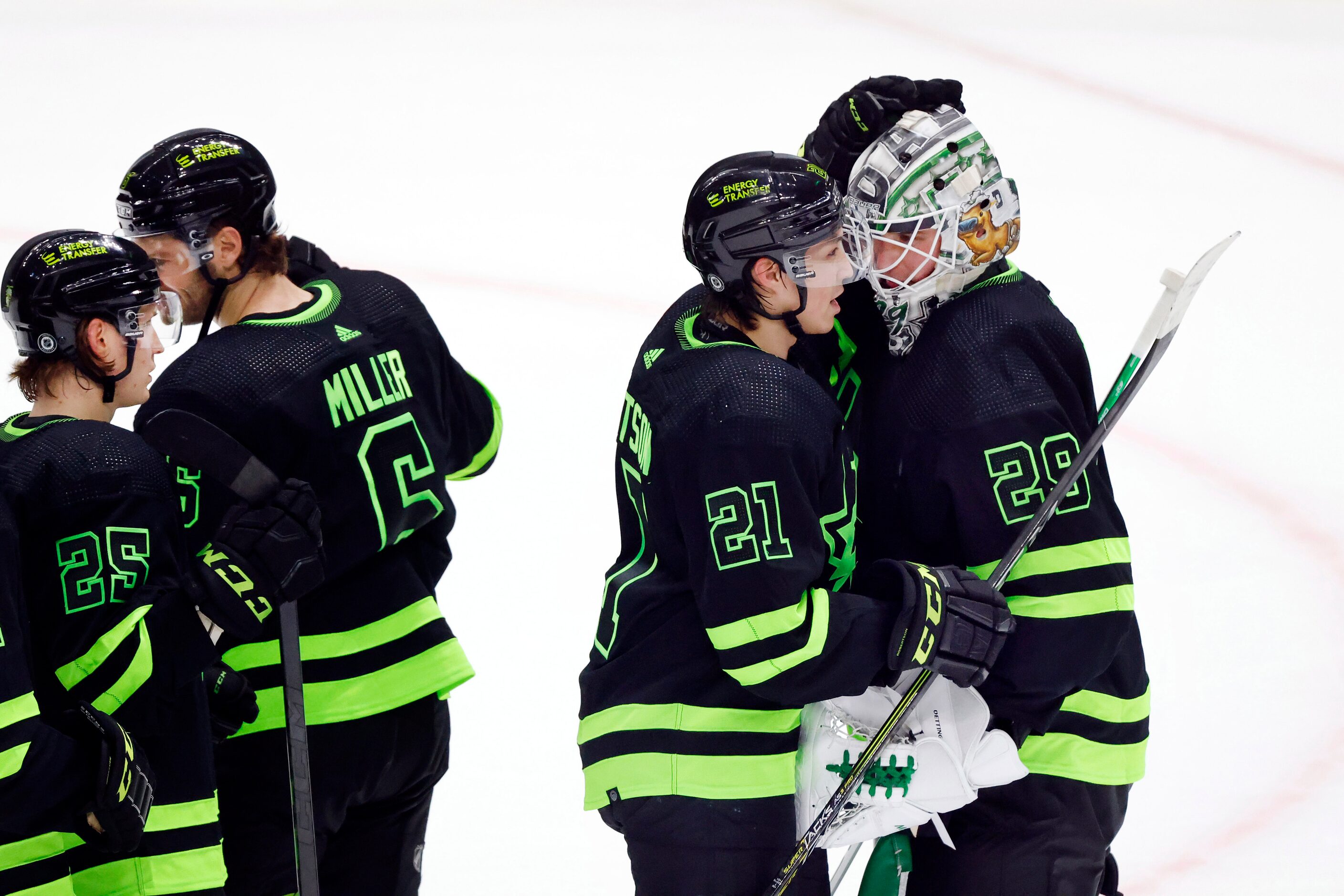 Dallas Stars goaltender Jake Oettinger (29) receives  a hug from Jason Robertson (21) after...