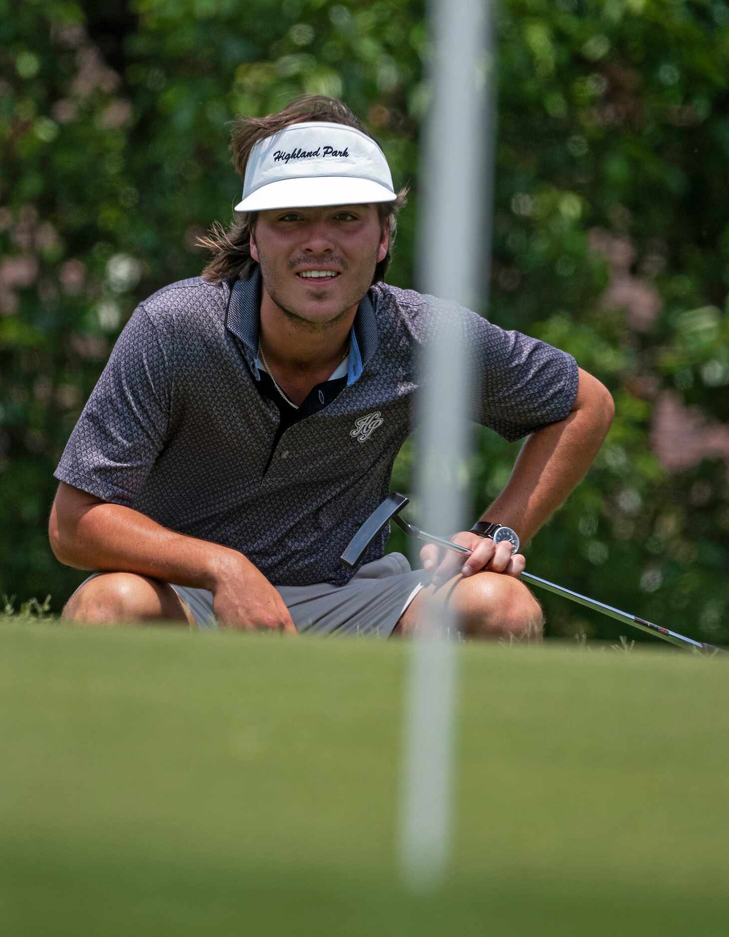 Highland Park, Christian Clark, reads the no. 15 green before attempting a putt down during...