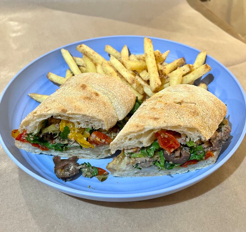 La Bodega Rotisserie + Goods makes a sandwich with sardines, roasted tomatoes, olives,...