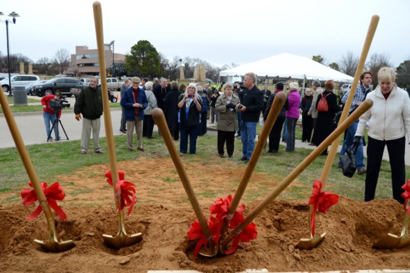 Residents take pictures of the ceremonial shovels following the groundbreaking of the South...
