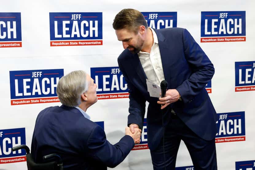 Texas Gov. Greg Abbott greets state Rep. Jeff Leach during a campaign event on Tuesday, Feb....