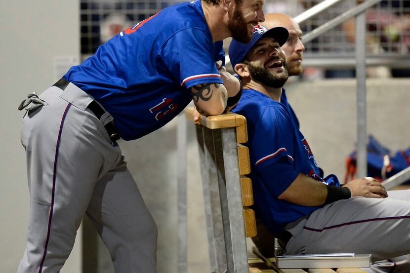 Texas Rangers' Josh Hamilton, left, talks with teammate Mitch Moreland in the dugout during...