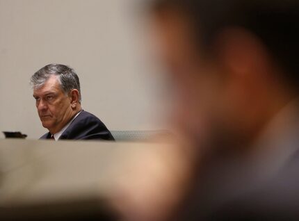 Dallas Mayor Mike Rawlings listens to an HMK tenant in West Dallas speak.