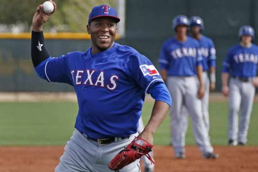 Texas pitcher Neftali Feliz works during rundown drills during Texas Rangers baseball spring...