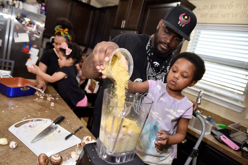 James McGee, shown helping his daughter pour ingredients for a vegan pasta at their DeSoto...