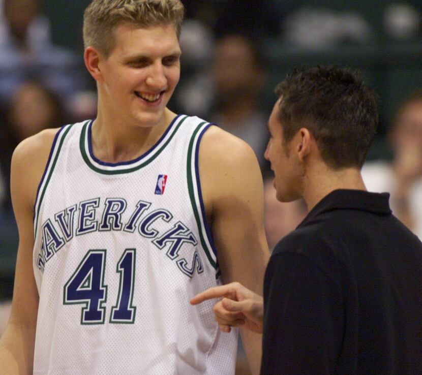 Dallas Mavericks player Dirk Nowitzki, left, jokes with Steve Nash in the Mavs' 95-93...