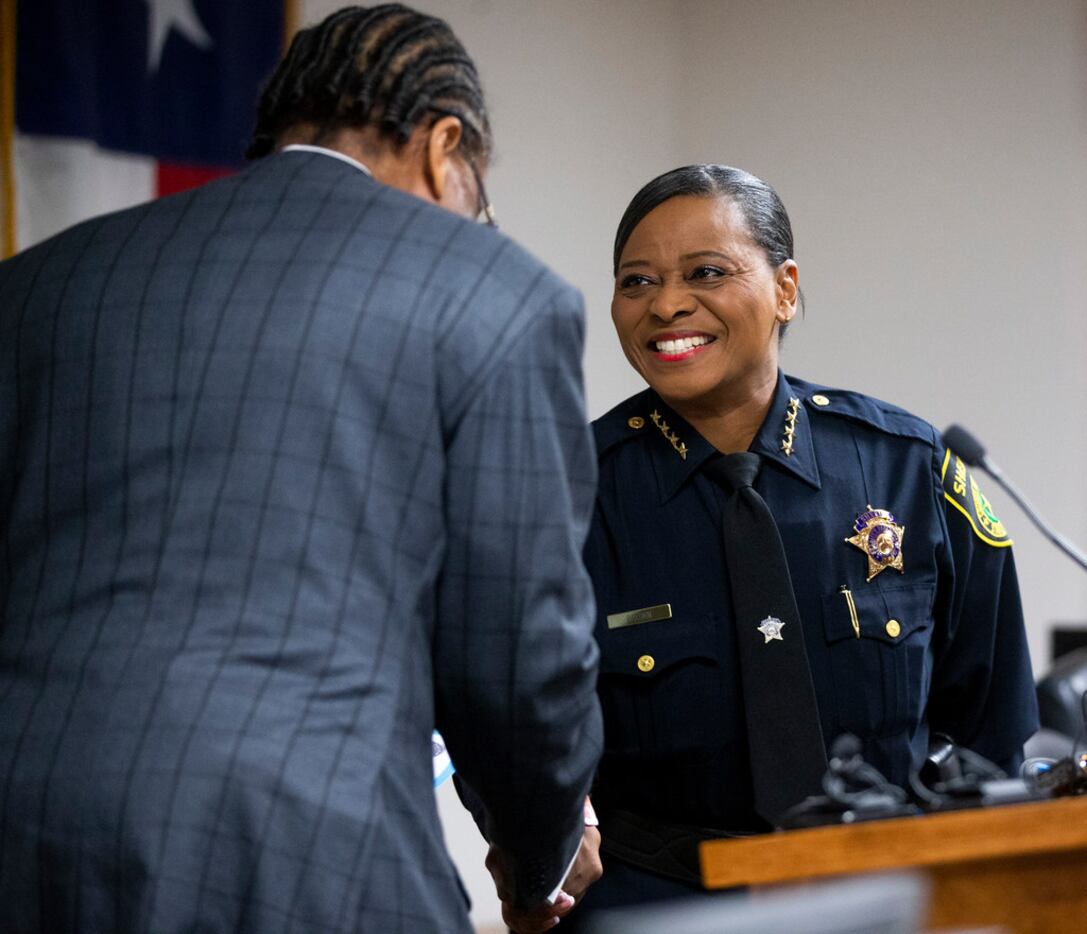 Dallas County Commissioner John Wiley Price shakes hands with Sheriff Marian Brown after...