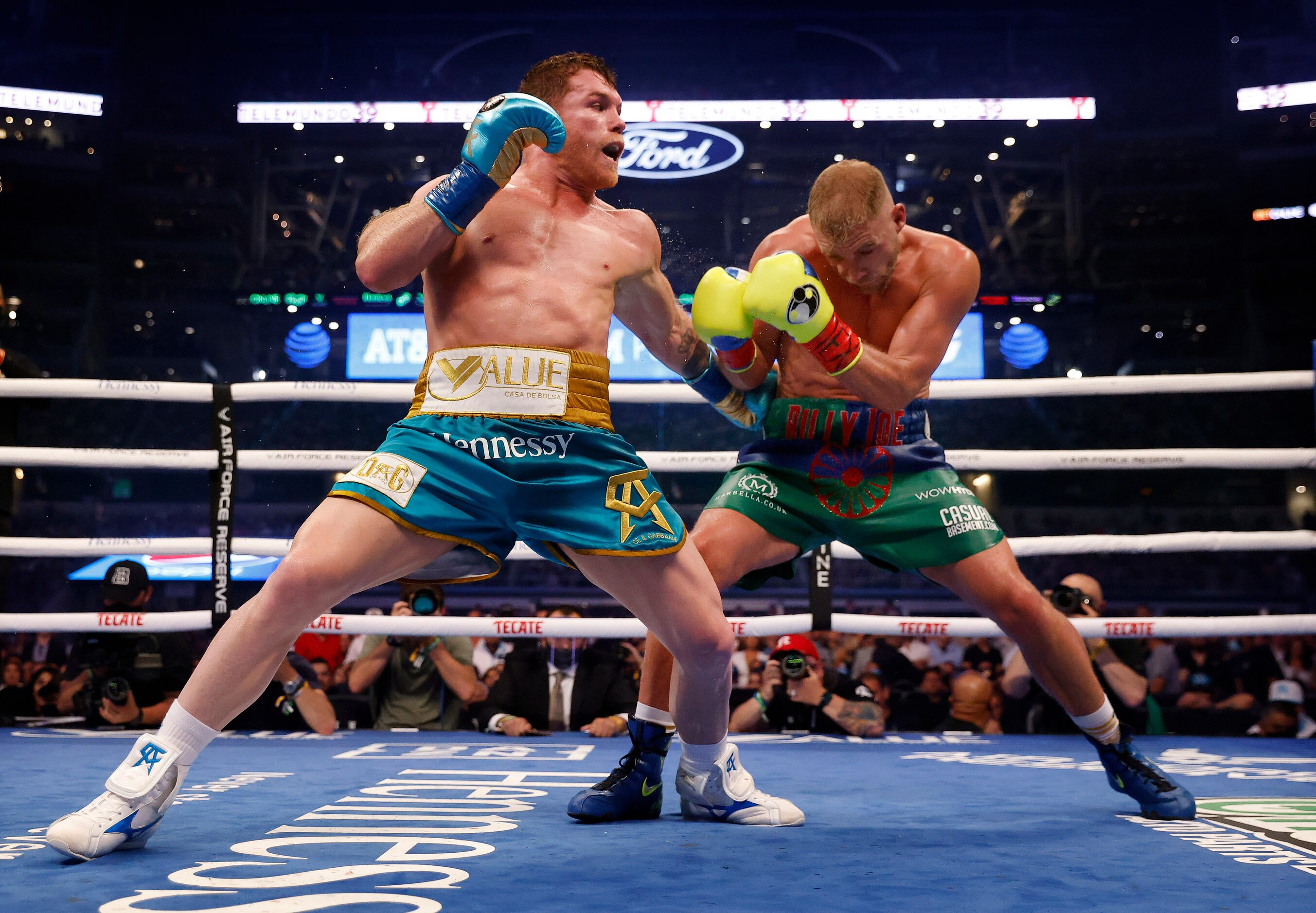 Boxer Canelo Alvarez (left) lands a punch on Billy Joe Saunders during their super...