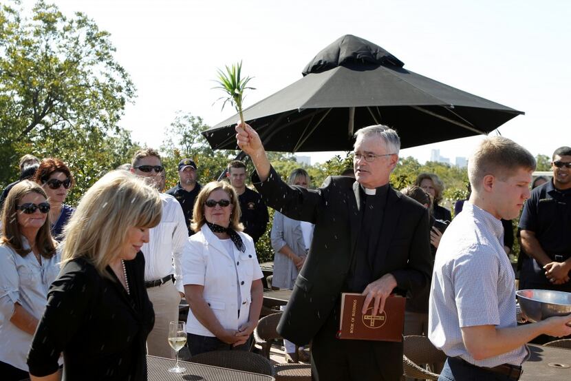  In this file photo from 2011, Father Greg Kelly blesses owner Jeannie Terilli on the...