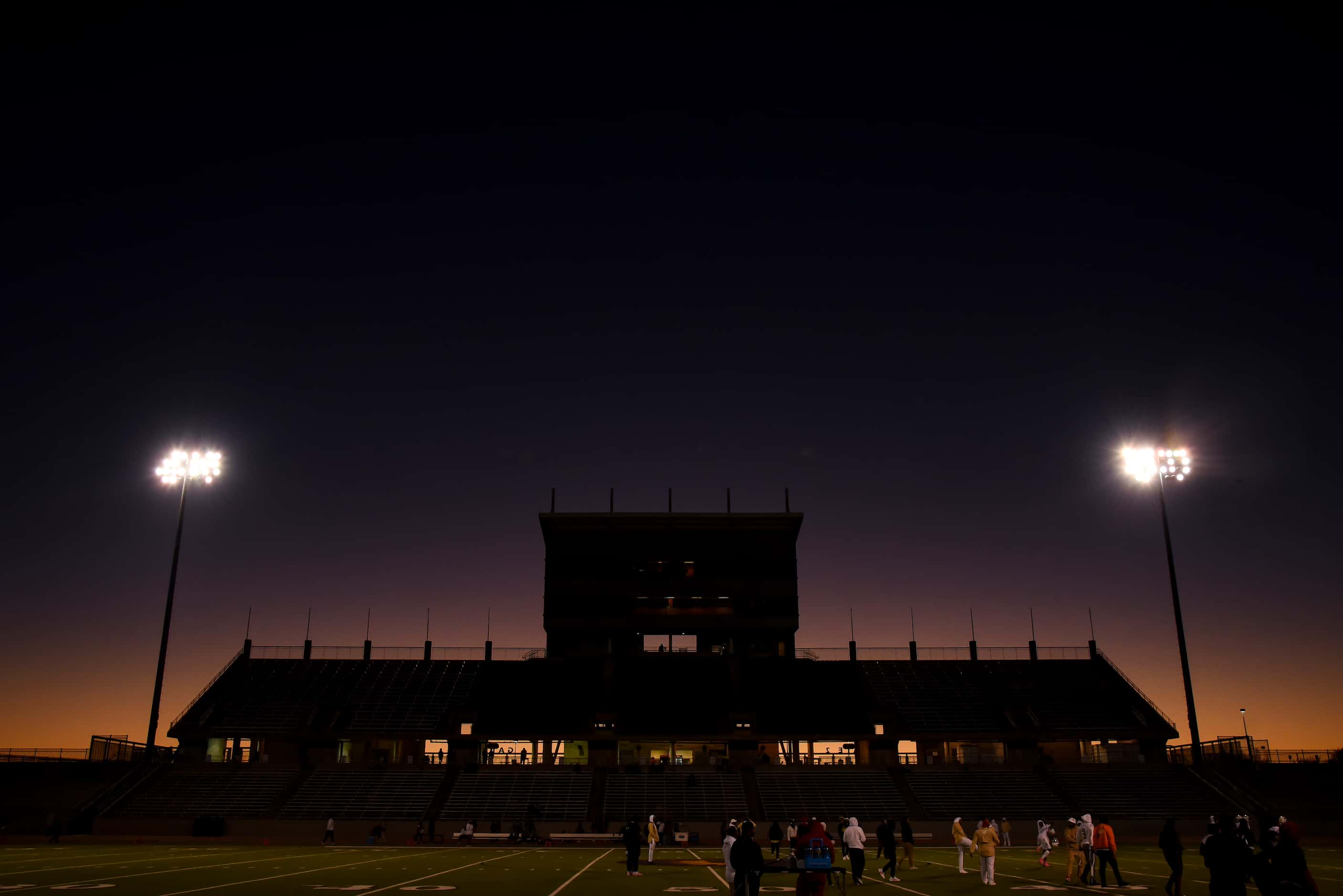 The sun sets before the start of the District 6-5A Division II title game between Kimball...