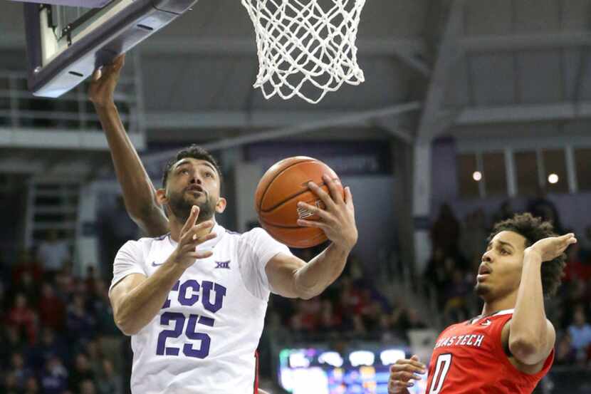 TCU Horned Frogs guard Alex Robinson (25) goes up for two against Texas Tech Red Raiders...