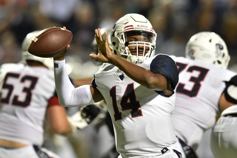 Allen junior quarterback Grant Tisdale (14) throws a pass to a teammate, while  being...