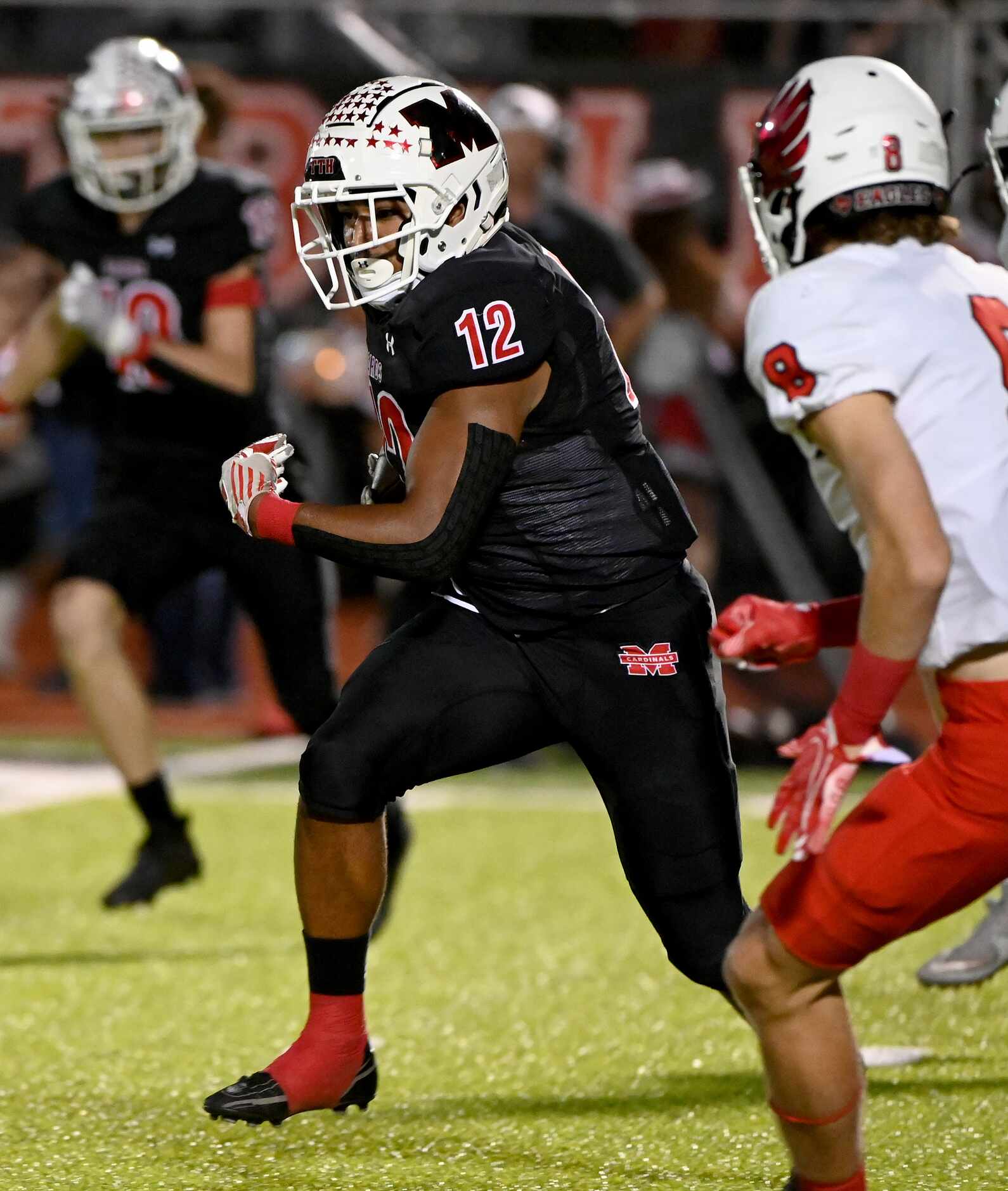 Melissa's Ashton Mitchell-Johnson (12) runs upfield in the first half of a high school...