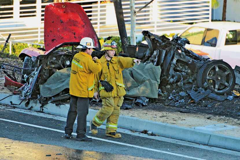 FILE - In this Nov. 30, 2013, file photo, sheriff's deputies work near the wreckage of a...