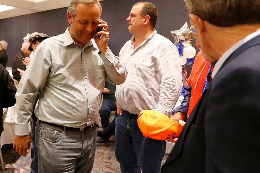 GOP state Rep. Rodney Anderson (left) talks on his cell phone as he walks in to make a...
