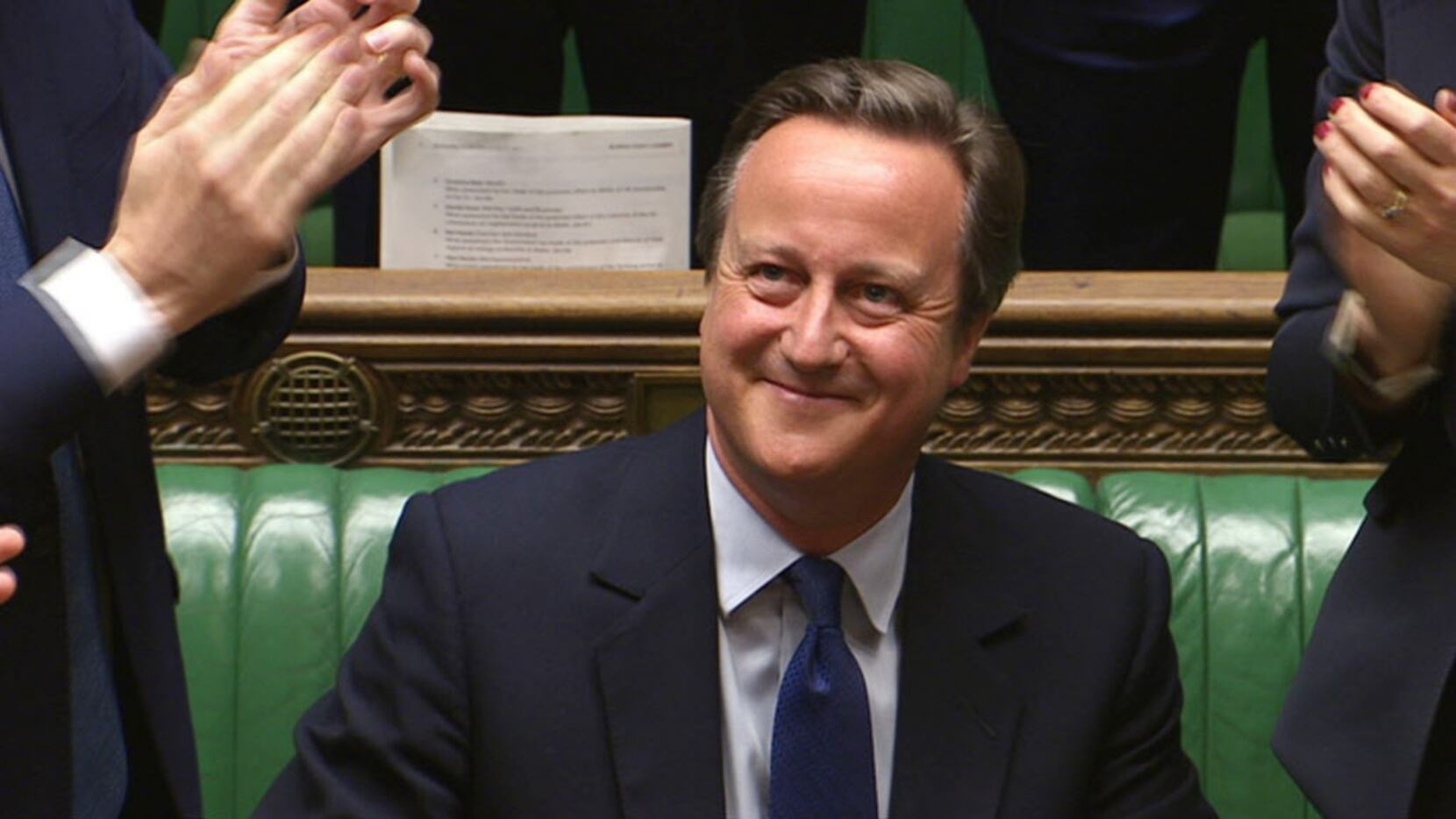 David Cameron receives a standing ovation from members of parliament at the end of his last...